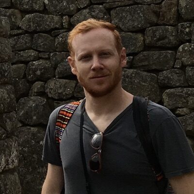 Zach Landes standing in front of ruins at Machu Picchu